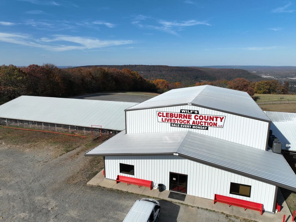 Aerial view of Wilf's Cleburne County Livestock Auction with the Ozark hills behind it